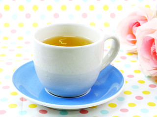 tea in cup on sweet polka dot background