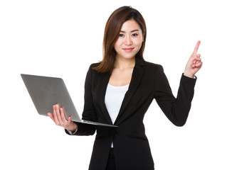 Asian Businesswoman use of the notebook computer and finger poin