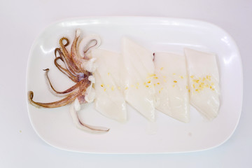 Raw squid slice on white dish isolate on white background ready