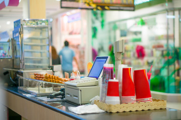 Empty cash desk with computer terminal in cafe in mall