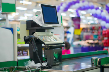 Close up of empty cash desk with computer terminal in supermarke