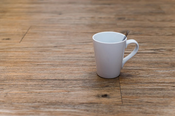 Empty white coffee mug on wooden table