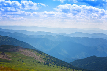 Beautiful mountain landscape with white clouds in the blue sky