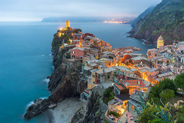 Illuminated at night the town on the rocks Liguria Italy