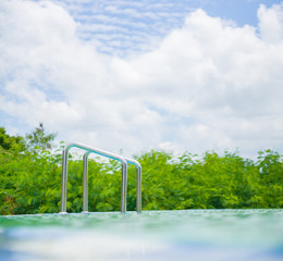 Shine metal ladder to small open air pool in aqua park