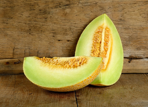 Yellow cantaloupe melon on the wooden background