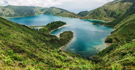 Panoramic view on Lagoa do Fogo, a crater lake within the Agua de Pau Massif stratovolcano in the center of the island of Sao Miguel in the Portuguese archipelago of the Azores. - obrazy, fototapety, plakaty