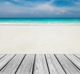 Fototapeta premium Wood Terrace on The Beach with Clear Sky,Blue Sea and White Sand to input Text