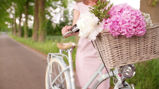 Flowers in the basket of a classic bicycle in a park