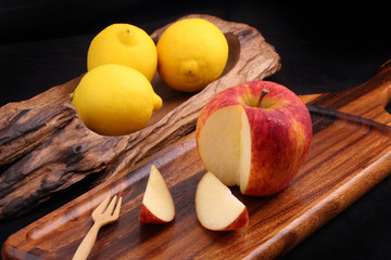 Cool organic fresh red apple on wooden tray with fork and cool l