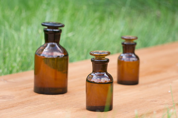 little brown bottles on booden board and grass