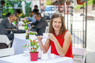 Beautiful brunette girl sitting in a coffee shop
