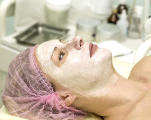 Cosmetician cleaning face