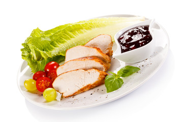 Roast chicken fillet and vegetables on white background 
