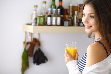Portrait of a pretty woman holding glass with tasty juice
