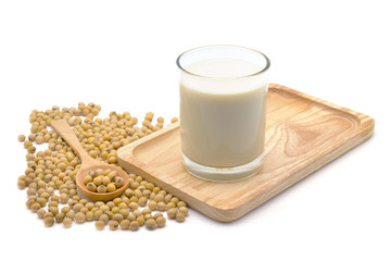Isolated soy beans and soy milk in a glass on wooden tray