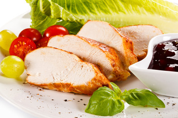 Roast chicken fillet and vegetables on white background 