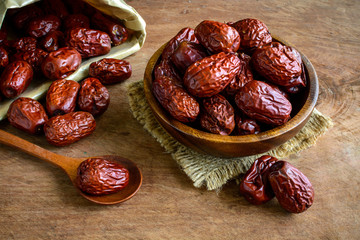 Dried jujube fruits on wooden table