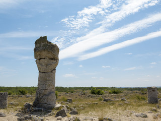 Fototapeta premium A stone pillar, on the background of blue sky