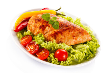 Roast chicken fillet and vegetables on white background 