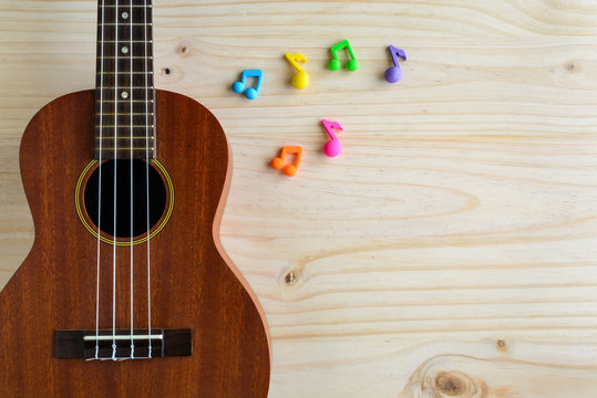 Close up of ukulele on old wooden background