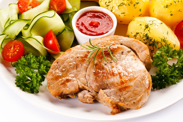 Fried steak, boiled potatoes and vegetable salad 