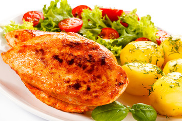 Fried chicken fillet, boiled potatoes and vegetable salad 