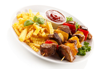 Grilled meat, French fries and vegetables 