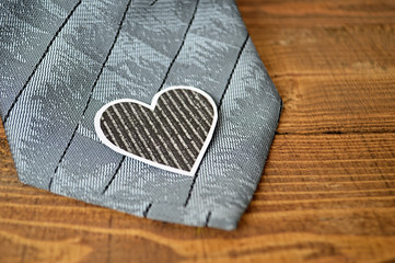 Father's Day gift: Grey tie and paper heart on wooden background