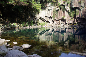 A small stream coming out of a small lake. The lake is fed from mountain springs. River flowing among large stones and is therefore almost invisible.
