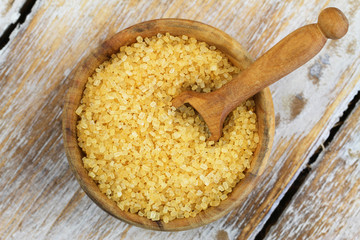 Brown sugar in wooden bowl, close up
