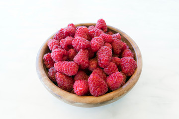 Fresh organic fruit - raspberry on wood background selective focus