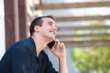 Fototapeta na wymiar Smiling man listening to mobile phone conversation