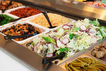 Various salads in gastronomical containers