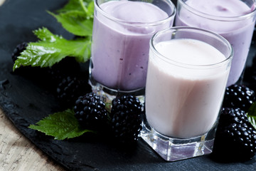 Homemade yogurt and milk cocktail with berry blackberries, selec