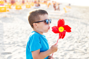 Little boy blow pinwheel