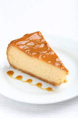 Fresh and tasty caramel cheesecake on white plate