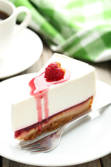 Fresh raspberry cheesecake on white plate