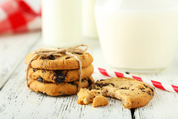 Cookies and glass of milk on white wooden background