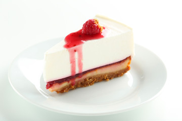 Fresh raspberry cheesecake on white plate