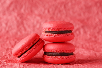 Red macarons on red paper background