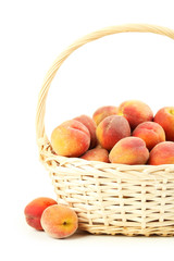 Fresh peach fruit in basket on a white background