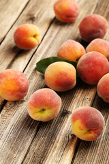Ripe peaches fruit on a brown wooden background
