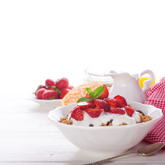 Fresh strawberries , yogurt and homemade granola
