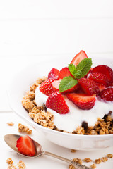 Yogurt with granola and fresh strawberries