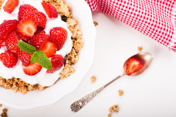 Yogurt with granola and fresh strawberries