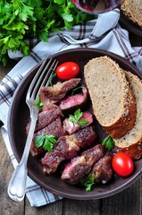 Delicious juicy rare beef steak with rye bread bran
