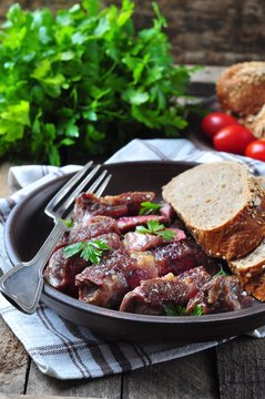 Delicious juicy rare beef steak with rye bread bran