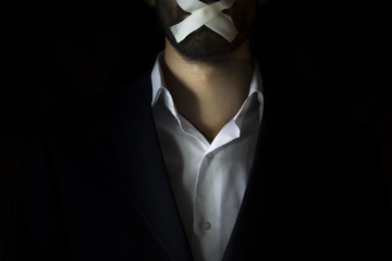 Business man with taped mouth