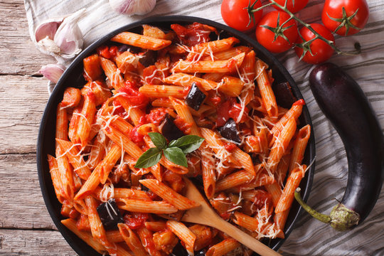 Italian Pasta alla Norma close-up and ingredients. horizontal top view
